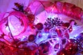 Christmas and valentinbackground is decorated with lights of garlands, sparkling red balls, snowflake and decorative