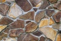 Background of a decorative wall made with flat stones of different shapes and colors