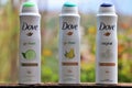 Three different spray air fresheners of the well-known brand `Dove`.