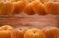 Background for design and creativity on Halloween day of orange pumpkins laid on long sides and boards with knots