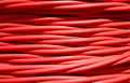 background of detailed red electrical cable used for high voltage power transmission from a power plant to substations Royalty Free Stock Photo