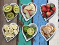 Background of diet food in heart shaped bowls set on vintage woo