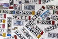 Background of different car license plates from different countries on a white wall Royalty Free Stock Photo