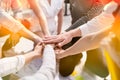 Background of diversity human bare hands join together in the middle under with warm natural sun light, Concept power of social