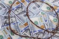 the background of dollars on it is barbed wire. close-up Royalty Free Stock Photo