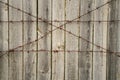 Background with a double row of barriers - from barbed wire and solid fence. Hard background in monochrome tones. Shallow DOF,