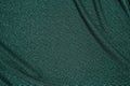 Background of draped dark green fabric with silver lurex thread Royalty Free Stock Photo