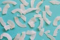 Background of dried coconut white chips on a blue background Royalty Free Stock Photo