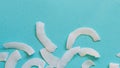 Background of dried coconut white chips on a blue background Royalty Free Stock Photo