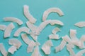 Background of dried coconut white chips on a blue background Royalty Free Stock Photo
