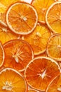 Background of dried orange slices. Fruit snacks or dehydrated crispy slices. Vegetarian food. Fruit chips