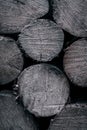 Background of dry chopped firewood logs stacked up on top of each other black blue Royalty Free Stock Photo