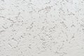 Background of embossed white wall trimmed with decorative plaster