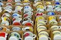 Background of enamel mugs with logos of automobile firms.