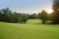 Background of evening golf course has sunlight shining down at golf course in Thailand Royalty Free Stock Photo