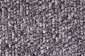 Background from a fabric texture. Wool knitted fabric with cable seamless pattern of white black color. Textile closeup.Concept of Royalty Free Stock Photo