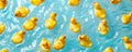 A background filled with numerous yellow rubber ducks floating on a light blue water surface, Royalty Free Stock Photo