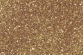 Background filled with shiny holographic gold glitter. Low contrast photo. Royalty Free Stock Photo