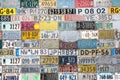 Background filled with various license plates