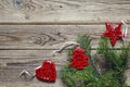 Background with fir branches and red Christmas decorations on old wooden boards. Space for text. Royalty Free Stock Photo
