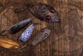 Background of fishing stuff. Lures and Hooks with grid for fish on a wooden table Royalty Free Stock Photo