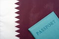 On the background of the flag of Qatar is a passport