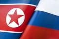 Background of the flags of the north korea and Russia. The concept of interaction or counteraction between the two