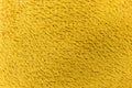 Background from fleecy fabric of yellow synthetic wool