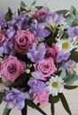 Background of flowers, pink roses, chamomile and blue freesias.