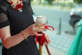 The girl decorated with a decorative candlestick in her hands and a sign . holds a candle in her hand . in the background without