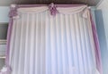 Background of folded curtains decorated in purple and white walls. Wedding Curtains pink background, blank interior room for girl