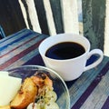 Background - food, cup with coffee and a plate with grapes on the balcony