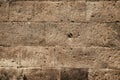 Background in the form of dark stone masonry in the wall of an ancient church or house. The texture of a speckled sandstone Royalty Free Stock Photo