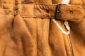 Background in the form of a fragment of the back of a winter jacket made of genuine brown soft leather