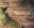 Background frame with pine tree branch on old wooden background board Royalty Free Stock Photo