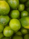 Background of fresh green limes closeup, fruits on sale, mobile photo