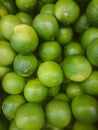 Background of fresh green limes closeup, fruits on sale, mobile photo Royalty Free Stock Photo