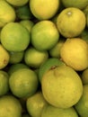Background of fresh green limes closeup, fruits on sale, mobile photo