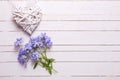 Background with fresh tender blue flowers and decorative heart