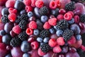 Background of fresh vegetables and fruits. Ripe blackberries, blueberries, plums, pink grapes, raspberries. Mix berries and fruits Royalty Free Stock Photo