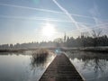 Background with wood path walkway at lake shore on a calm tranquil winter morning. Frost hoar wooden pier Royalty Free Stock Photo