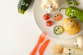 Background with funny vegetables plate served for children on table