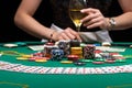Background of a gaming casino, poker table, cards, chips and a girl with a glass of wine in the background. Background for a Royalty Free Stock Photo