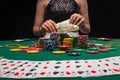 Background of a gaming casino, poker table, cards, chips and a girl with a glass of wine in the background. Background for a Royalty Free Stock Photo