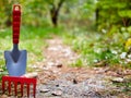 Background, garden cleaning, small shovel, rake, on left Royalty Free Stock Photo