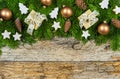 Christmas gifts on fir branches border and decorations on wood background Royalty Free Stock Photo