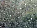 Background of glass covered with falling drops of heavy rain.