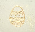 Background with glittering Easter egg on paper in nostalgic colors, made with golden glitter