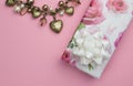 Background with gold heart and pearl necklace, wrapped rose gift