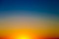 Background with gradient sunset sky in tones of yellow, orange and blue Royalty Free Stock Photo